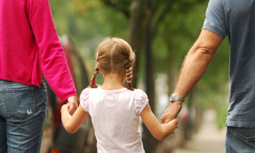 girl walking with parents