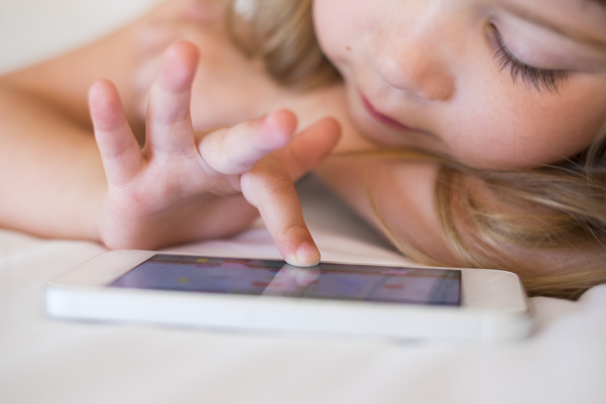 little girl playing with iPhone