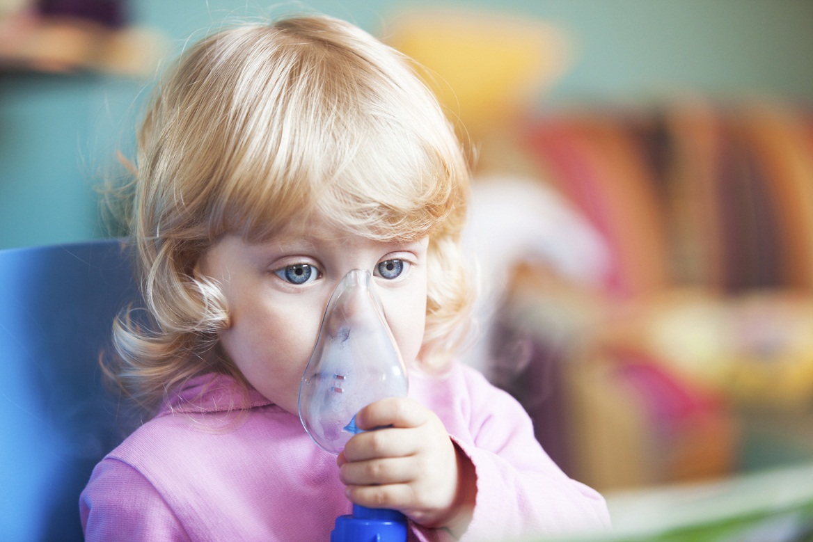 little girl with inhaler for asthma