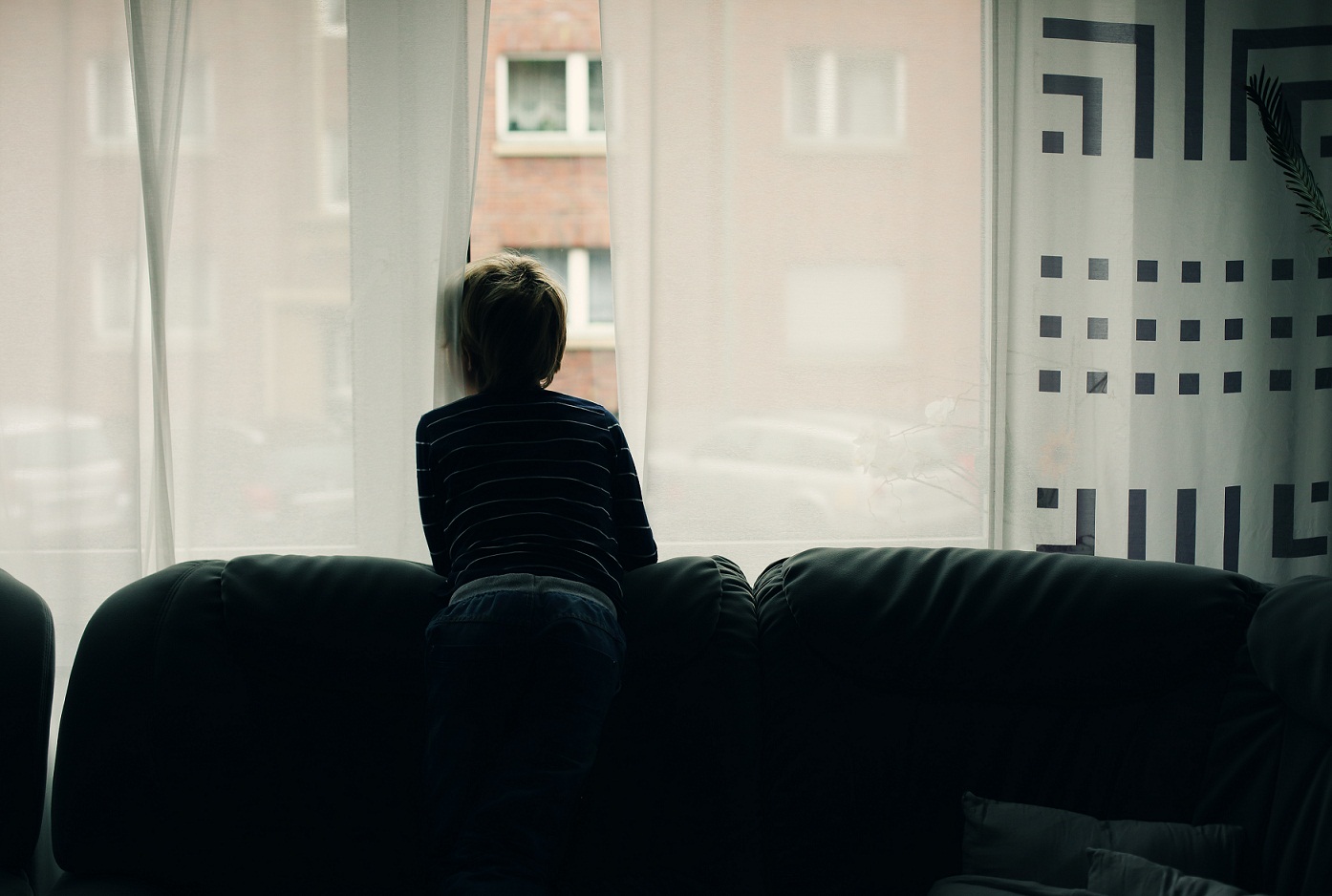 7 years old boy looking to the street