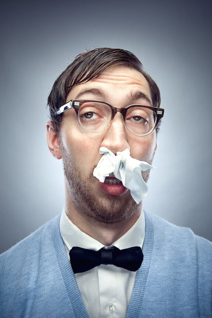 nerdy guy with tissues up his nose