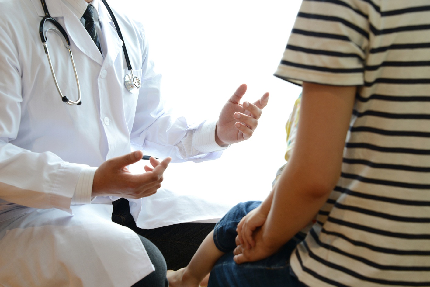 doctor talking to parent and child