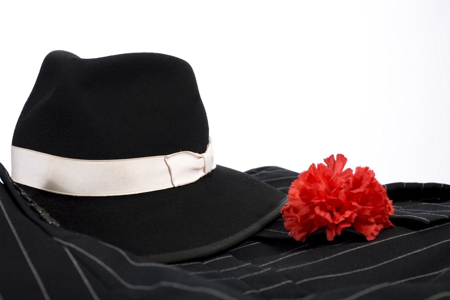 1920’s suit, red carnation in lapel, fedora hat. Gangster clothing.