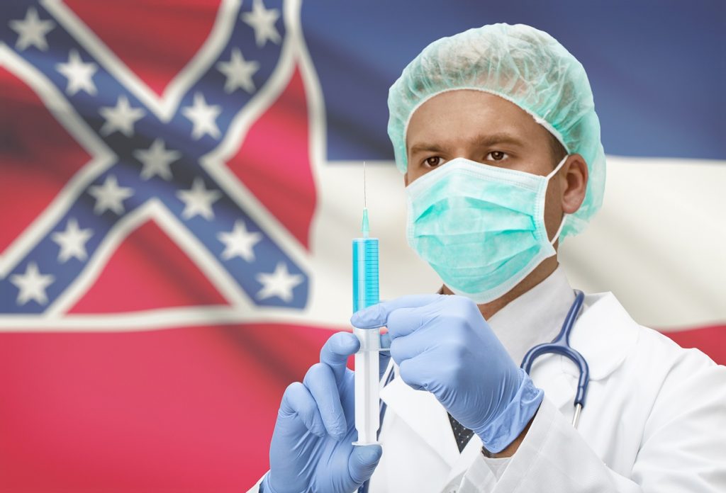 Mississippi flag and doctor holding syringe