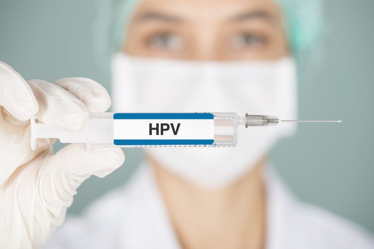 nurse holding up HPV vaccine