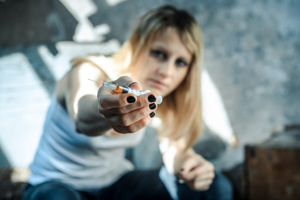 woman offering syringe