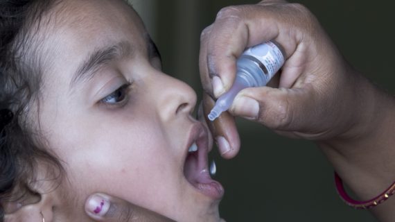 girl receiving oral polio vaccine OPV Vaccine Plus A Shot of Antibiotics Equals Polio