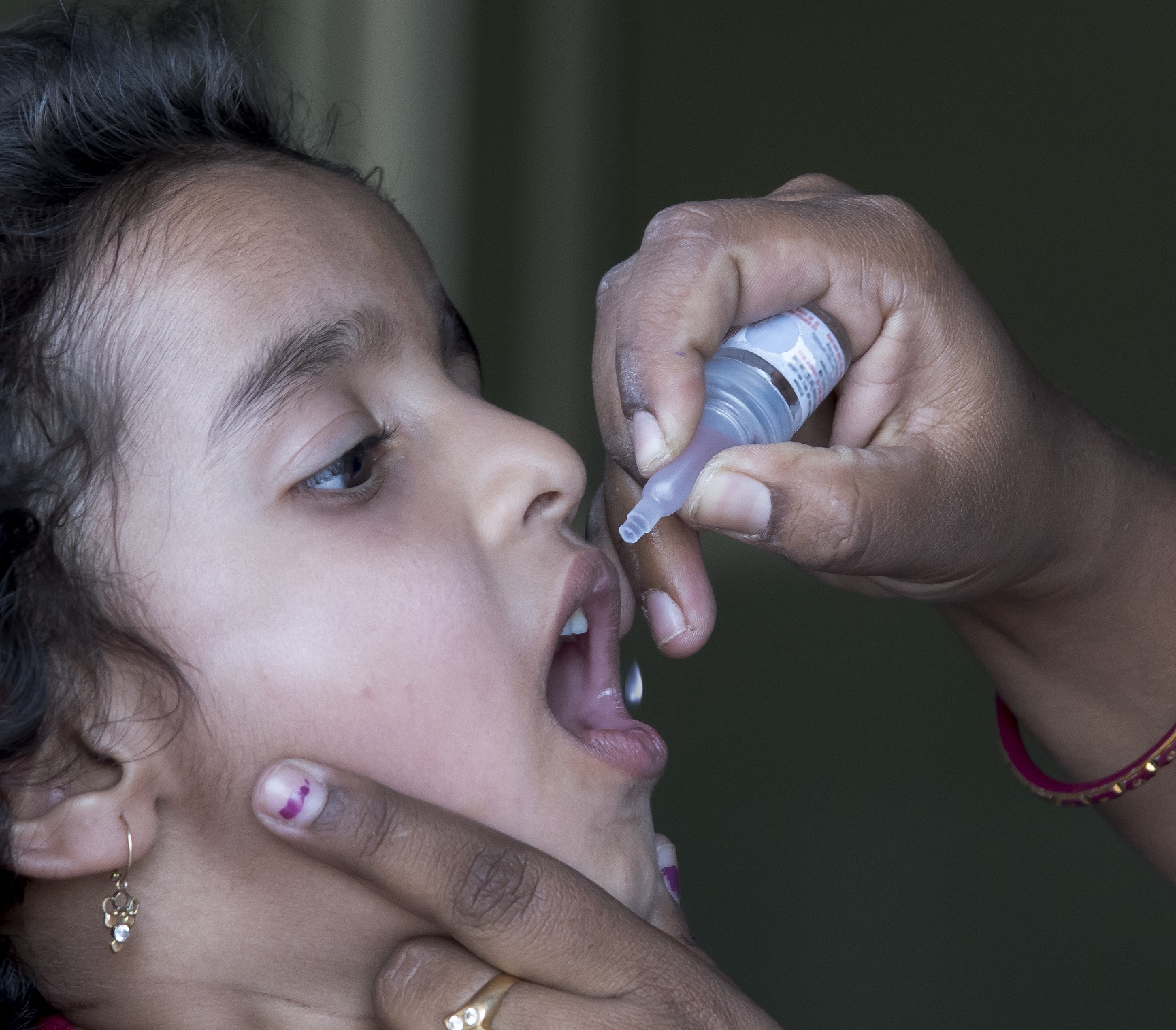 girl receiving oral polio vaccine