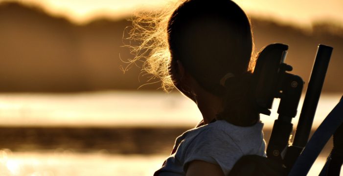 girl in a wheelchair ‘Modern Polio’ Cases Confirmed in 16 States