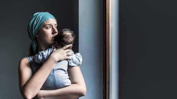 thoughtful mother holding baby Professor Says Parents Have No Right to Refuse Vaccines for Their Children