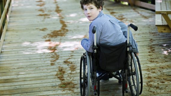 boy in a wheelchair AFM Compared to Guillain-Barré Syndrome