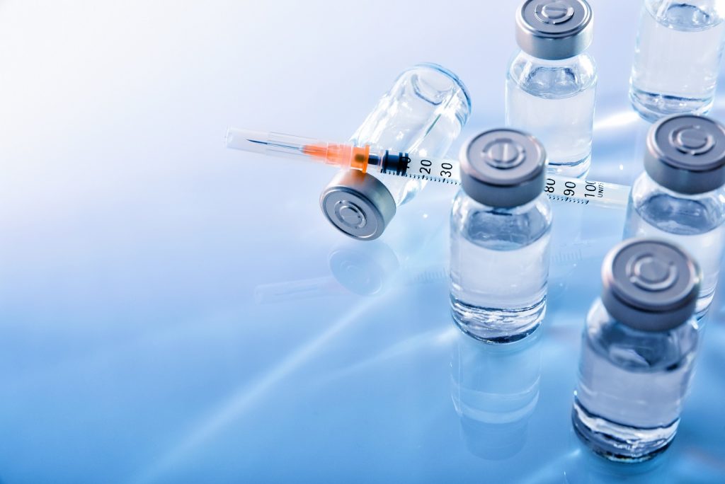six vaccines and a syringe