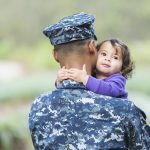 US soldier holding daughter