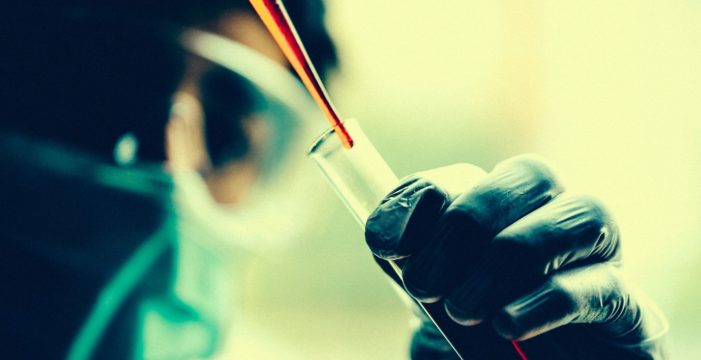scientist with a test tube Arizona Bill Proposes Full Disclosure of Vaccine Ingredients and Side Effects