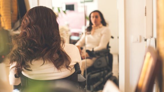 woman in a wheelchair looking at herself in the mirror Woman Paralyzed by Tetanus-Diphtheria Vaccine Still ‘Firmly Pro-Vaccine’