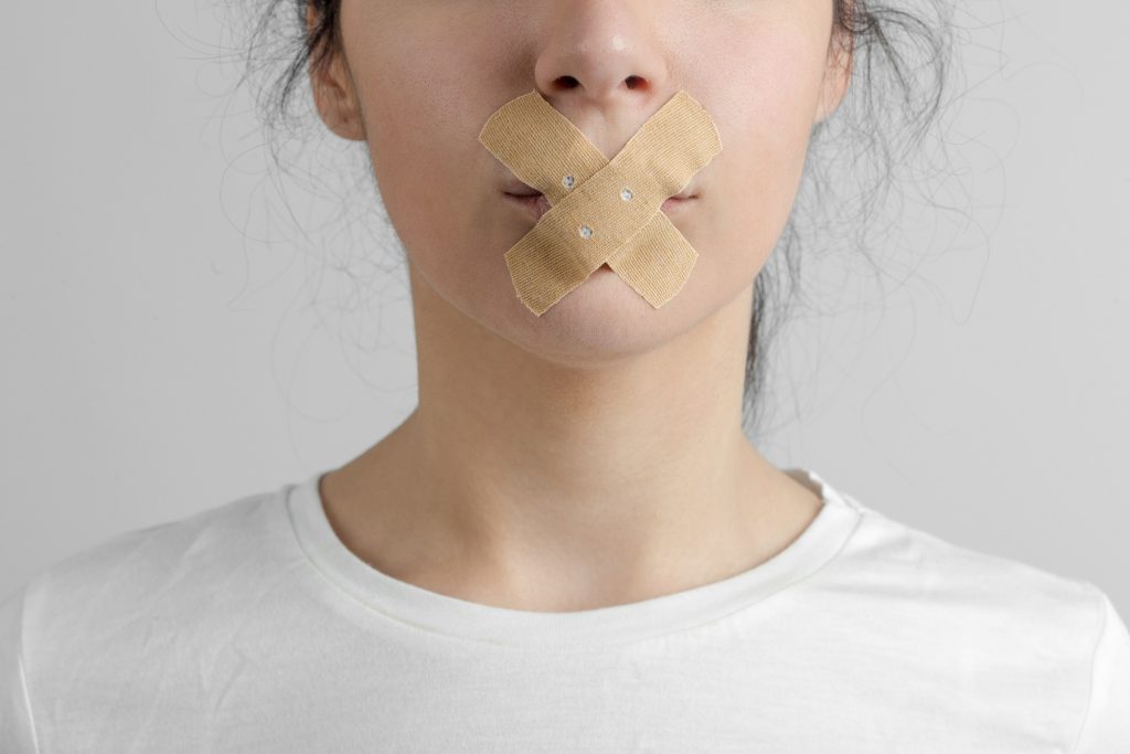 woman's mouth taped shut