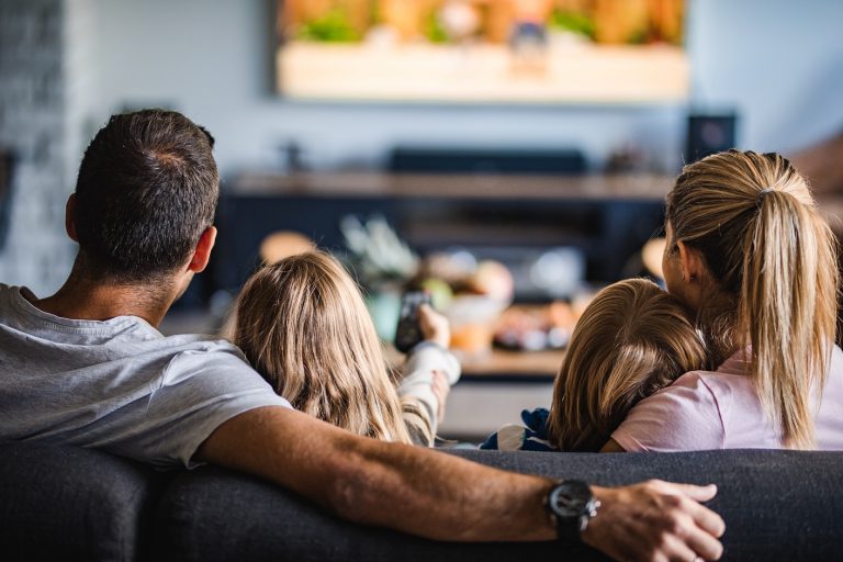 family watching TV on couch