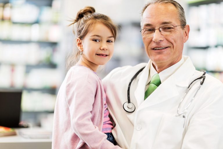 pharmacist holding little girl