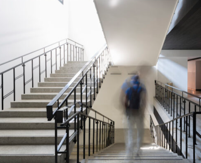 student walking down steps Fully Vaccinated School in Houston Closes Due to Pertussis Outbreak