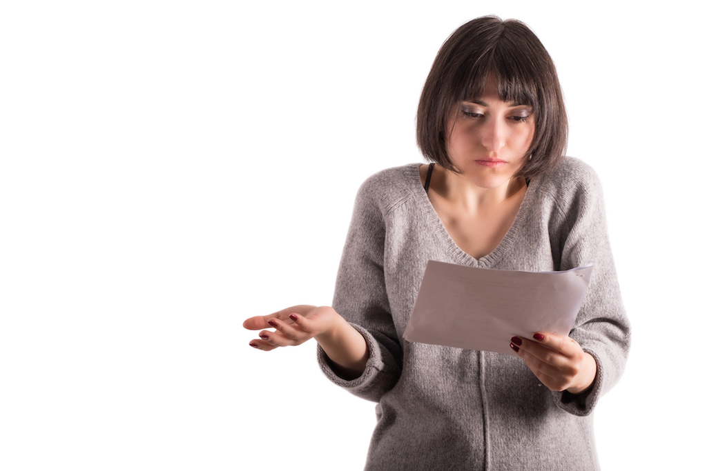 confused woman staring at paper