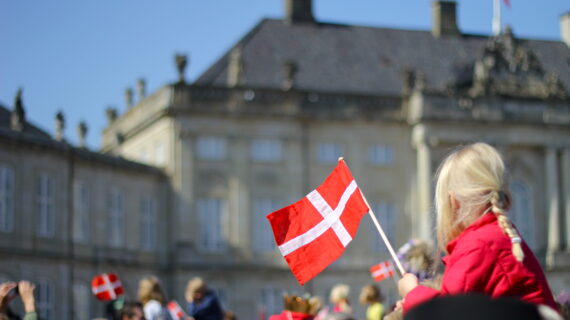 girl holding Danish flag Denmark Citizens Refuse Law Mandating Forced COVID-19 Vaccine