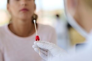 applying PCR test to woman