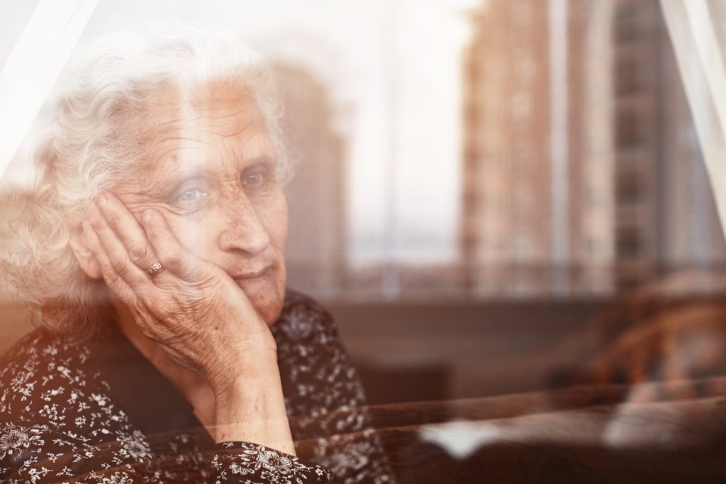 elderly woman looking out window