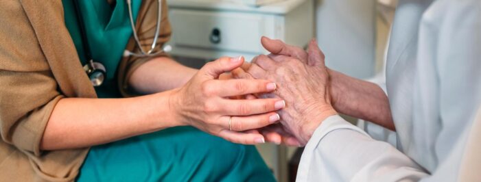 holding hand of elderly person 60 Percent of Nursing Home Workers in Ohio Decline COVID-19 Vaccines Over Safety Concerns