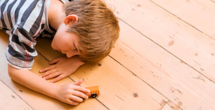 boy playing on wooden floor Autism Prevalence Rates in U.S. and Northern Ireland Continue to Rise