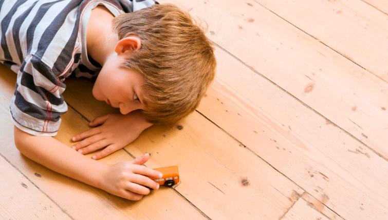 boy playing on wooden floor