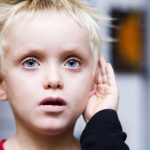 blond boy cupping his hand