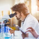 doctor looking into microscope