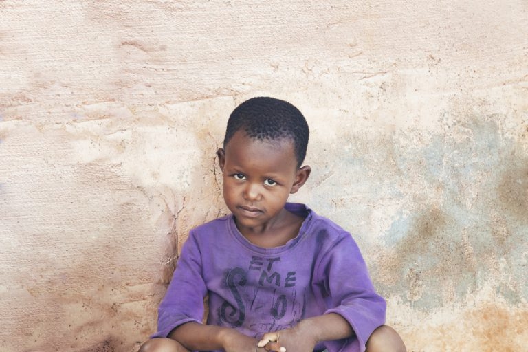 African boy in purple shirt