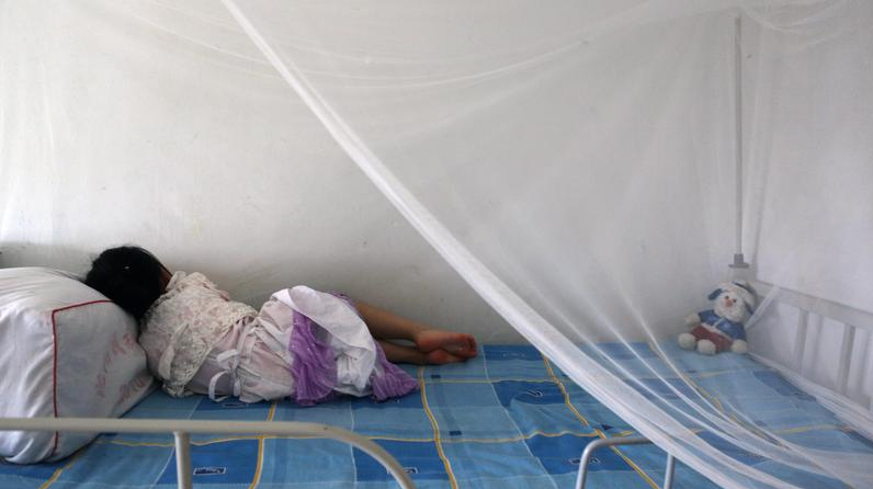 young girl laying in hospital bed
