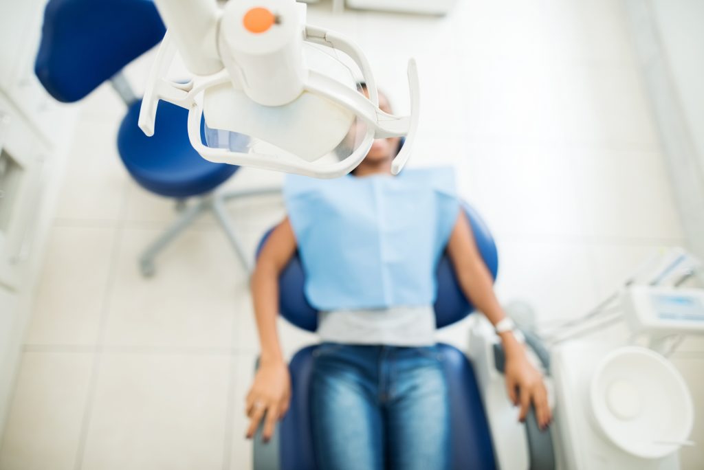 girl laying in dentist chair
