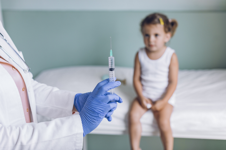 little girl waiting to get vaccinated