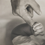 holding baby's fingers