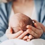 mother holding baby's head